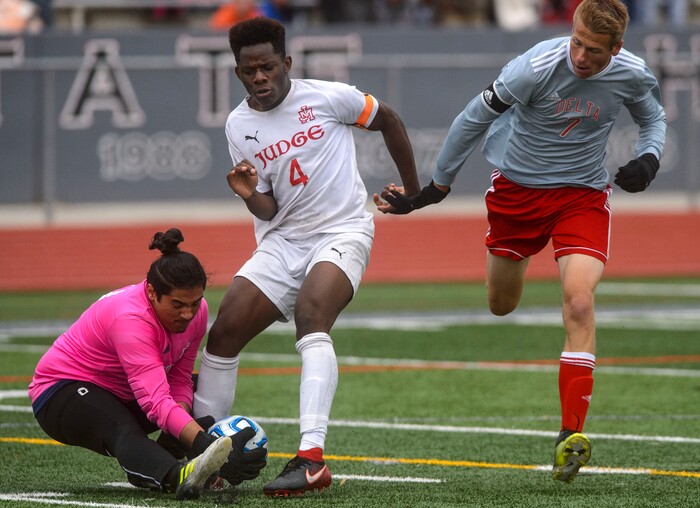 (Steve Griffin  |  The Salt Lake Tribune) Judge's Ferdinand Bambabate and goal keeper Caleb Castro crash together as they keep the ball away from Delta's Tanner Gonnder during the  Class 3A boys' soccer state semifinal at Alta High School in Sandy Friday May 11, 2018.