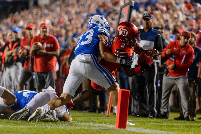 (Trent Nelson | The Salt Lake Tribune)  Utah Utes running back Zack Moss (2) is pushed out of bounds by Brigham Young Cougars defensive back Zayne Anderson (23) just short of the end zone as BYU hosts Utah, NCAA football in Provo, Saturday September 9, 2017.