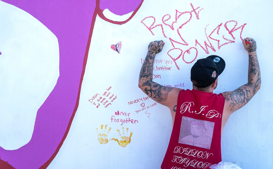 (Rick Egan | The Salt Lake Tribune) Josh Siegel, writes a message next to the mural of his brother, Dillon Taylor, who was shot by the police 7 years ago. Wednesday, Aug. 11, 2021.