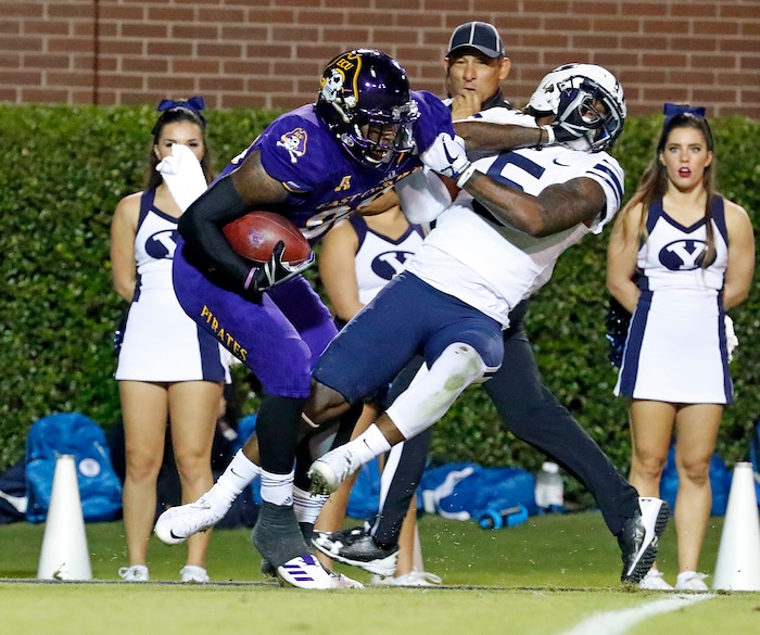 East Carolina's Trevon Brown (88) tries to break away from BYU's Dayan Ghanwoloku (5) \during the first half of an NCAA college football game in Greenville, N.C., Saturday, Oct. 21, 2017. (AP Photo/Karl B DeBlaker)