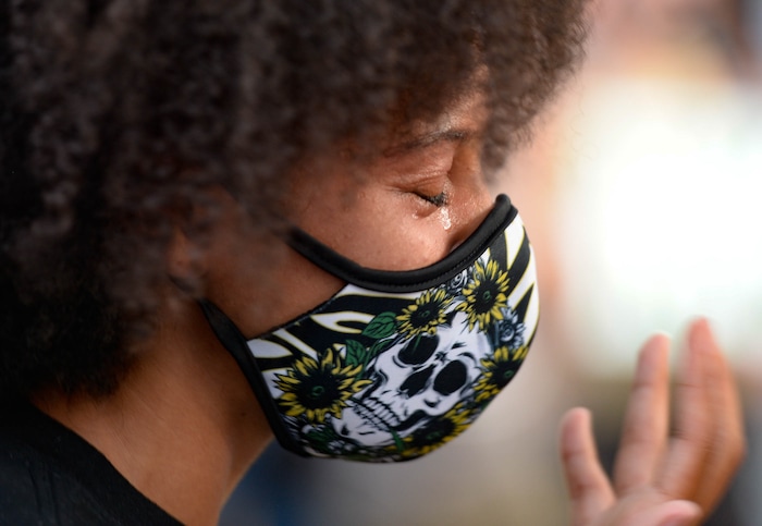 (Francisco Kjolseth  |  The Salt Lake Tribune) Rae Duckworth, cousin of Bobby Duckworth who was killed by a police officer in 2019 becomes emotional as she is presented with a special with his image during a protest outside of the governors mansion on Saturday, July 18, 2020.