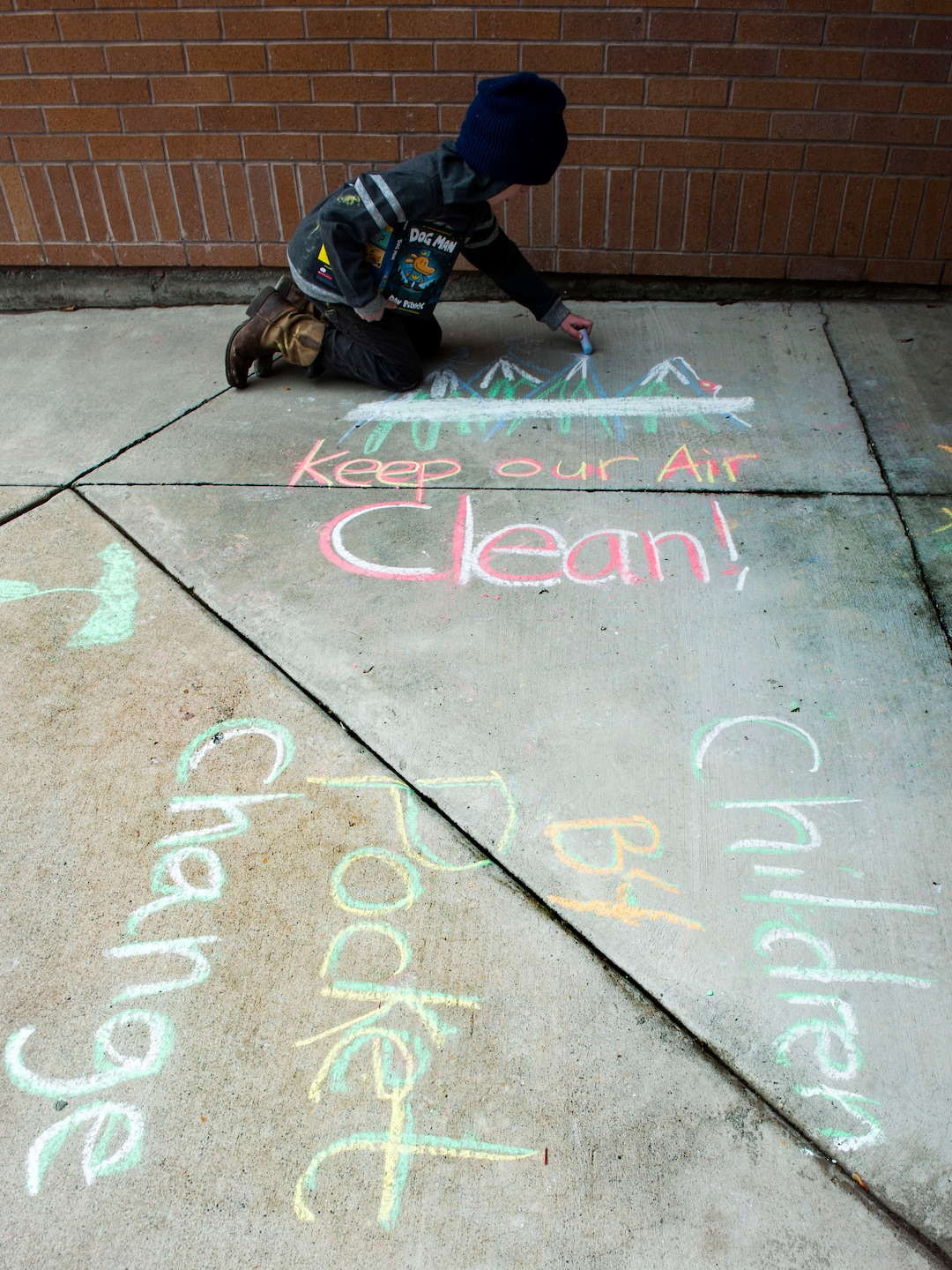 (Rick Egan  |  The Salt Lake Tribune)   William Hoffert 8, draws on the side walk in front of the Lehi City Hall, to protest the expansion of Geneva Rock's mining activities near their neighborhood, Tuesday, April 2, 2019.