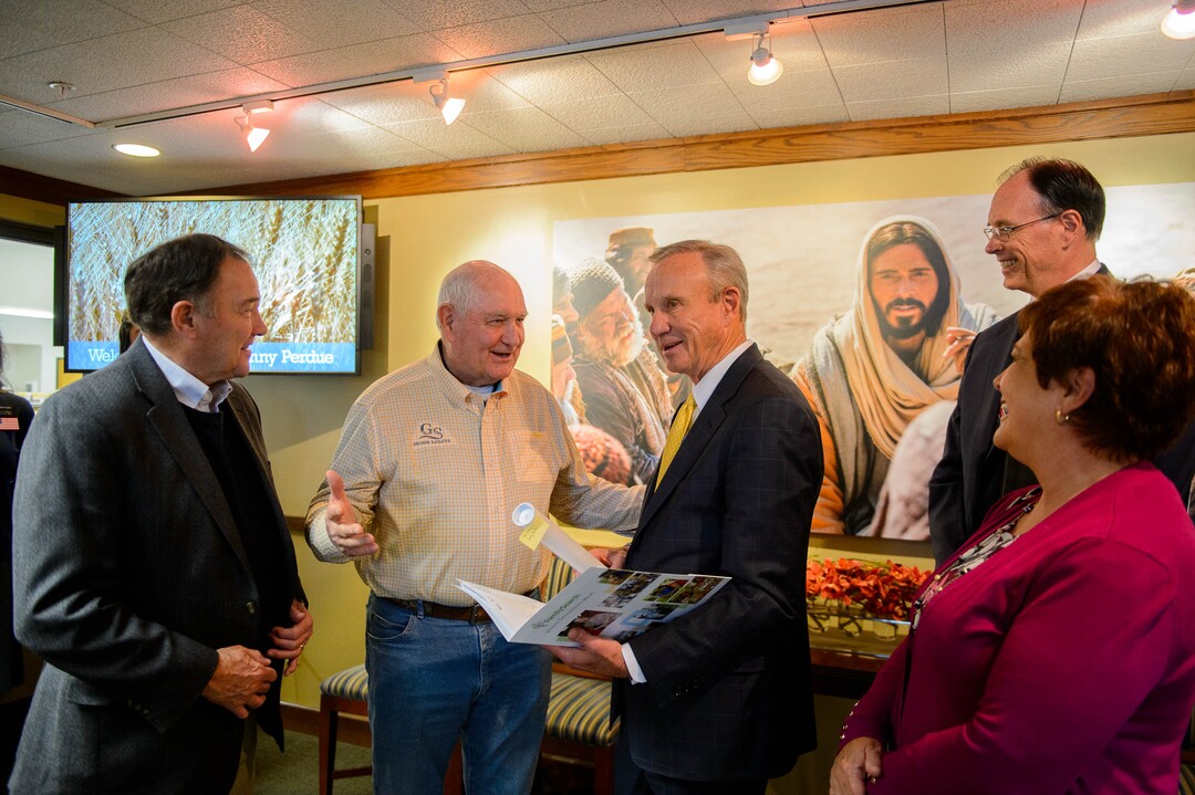 (Trent Nelson  |  The Salt Lake Tribune)  Elder Bradley D. Foster presents Agriculture Secretary Sonny Perdue materials related to his family history during a tour of Welfare Square in Salt Lake City on Wednesday May 22, 2019. From left, Gov. Gary Herbert, Perdue, Foster, Jeanette Herbert, and Bishop W. Christopher Waddell.