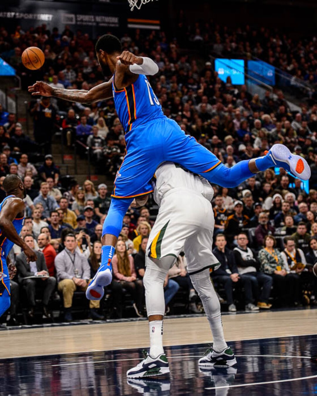 (Trent Nelson | The Salt Lake Tribune)  Oklahoma City Thunder forward Paul George (13) blocks a shot by and leaps over Utah Jazz forward Thabo Sefolosha (22) as the Utah Jazz host the Oklahoma City Thunder, NBA basketball in Salt Lake City, Saturday December 23, 2017.