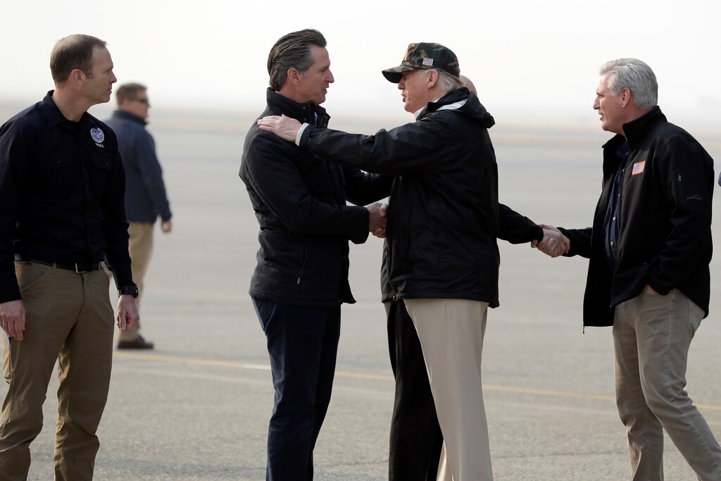 (Evan Vucci  |  AP Photo)  President Donald Trump greets California Gov.-elect Gavin Newsom as he arrives on Air Force One at Beale Air Force Base for a visit to areas impacted by the wildfires, Saturday, Nov. 17, 2018, at Beale Air Force Base, Calif. At left is Federal Emergency Management Agency administrator Brock Long and at right is House Majority Leader Kevin McCarthy of Calif., greeting Gov. Jerry Brown.