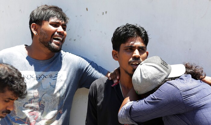 Relatives of people killed in Church blasts mourn as they wait outside mortuary of a hospital in Colombo, Sri Lanka, Sunday, April 21, 2019. Near simultaneous blasts rocked three churches and three hotels in Sri Lanka on Easter Sunday. (AP Photo/Eranga Jayawardena)