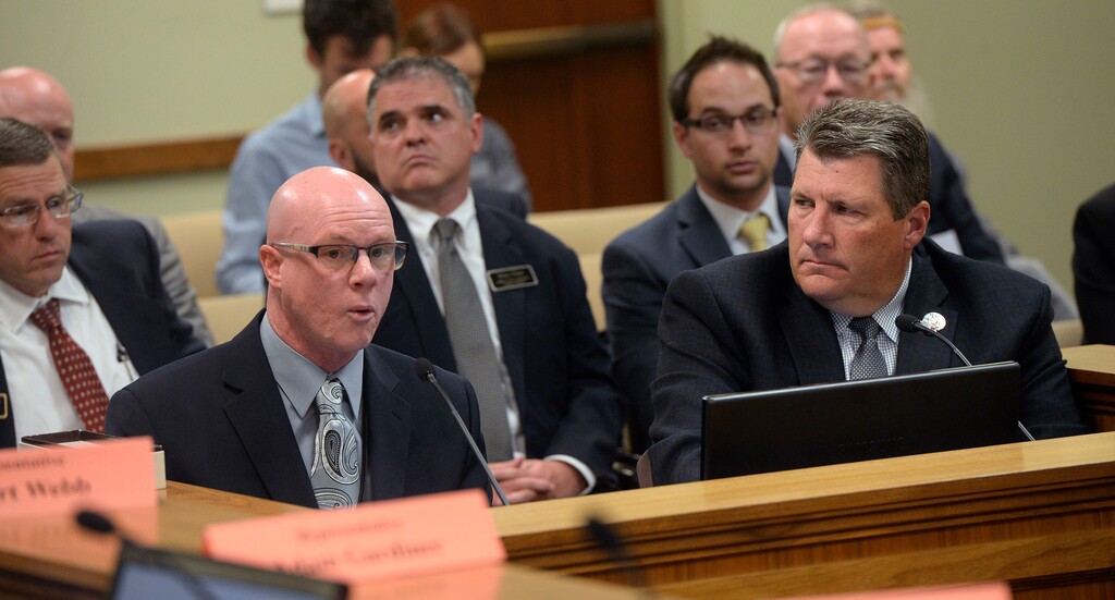 (Al Hartmann | Tribune file photo)
Dr. Viktor Kersey, Director of Institutional Programing, Dept. of Corrections, left, and Rollin Cook, Executive Director, Dept. of Corrections speak before the legislature's Law Enforcement and Criminal Justice Interim Committee Wednesday May 17. The committee is reviewing a recent audit report of the state's sex offender treatment program.