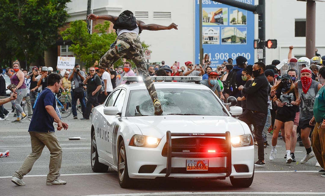 (Francisco Kjolseth  |  The Salt Lake Tribune) An officer tried to clear the scene in downtown Salt Lake City on Saturday, May 30, 2020.
