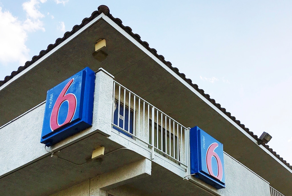 (Anita Snow | AP Photo) This Sept. 14, 2017, file photo shows a Motel 6 in Phoenix. The Motel 6 chain has agreed in a proposed settlement to pay up to $7.6 million to guests who say the company's employees shared their private information with immigration officials.