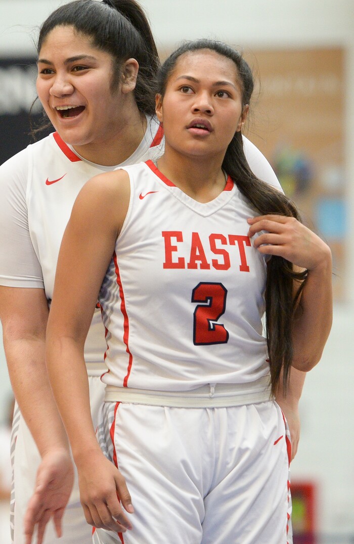 (Leah Hogsten  |  The Salt Lake Tribune) East's Lani Taliauli (54) celebrates the aggressive play of her teammate East's Margarita Satini (02). East faces Timpview in the championship game of the 5A High School Girls' Basketball Tournament at SLCC in Taylorsville, Saturday, Feb. 24, 2018.