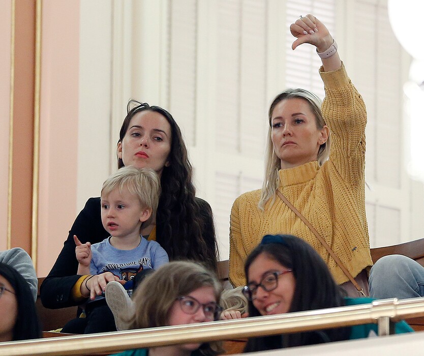 (Rich Pedroncelli | AP Photo) In this May 22, 2019 photo, an opponent of a measure to toughen the rules for vaccination exemptions gives a thumbs down as the bill's author, state Sen. Richard Pan, D-Sacramento, makes his closing statements in Sacramento, Calif. California Gov. Gavin Newsom and Pan have agreed to limit the role of public health officials in approving doctors' vaccine decisions. But the health officials will increase their oversight of doctors and schools with high numbers of medical exemptions. Sen. Richard Pan announced the changes Tuesday, June 18 after Newsom said he had doubts about giving state public health officials instead of local doctors the authority to decide which children can skip their shots before attending school.