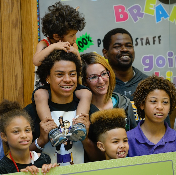 (Francisco Kjolseth  |  The Salt Lake Tribune)  Kearns High sophomore Keeven Wilson, 16, center left, celebrates with his blended family after being announced as the Granite School District's Absolutely Incredible Kid award winner during the school farewell assembly on Tuesday, May 22, 2018. Surrounded by his siblings Kingston, 2, foster parents Jessica and Marcus Wilson, Tyrese, 11, Kamani, 9, and Mya, 8, clockwise from top, Keenen is all smiles as he talked about maintaining his honor roll status and possibly studying psychology in college. 
