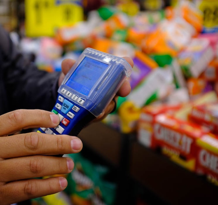(Trent Nelson | The Salt Lake Tribune)  
Smith's has introduced handheld scanners to five Utah stores - where shoppers carry a small device and scan and bag their groceries as they walk through the aisles. Adrian Ortega demonstrated one of the units at the Rose Park store, Monday April 16, 2018.