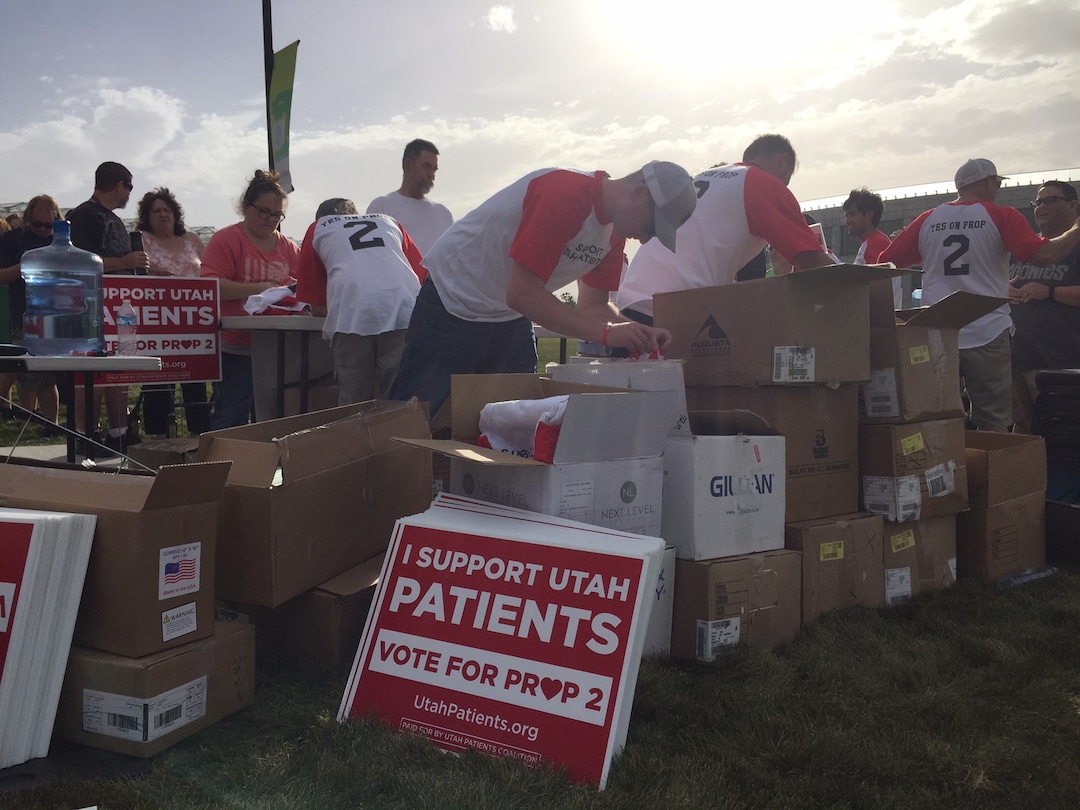 (The Salt Lake Tribune | Kathy Stephenson) Bo Johnson, helps distribute T-shirts and Saturday during the kick-off for Proposition 2.