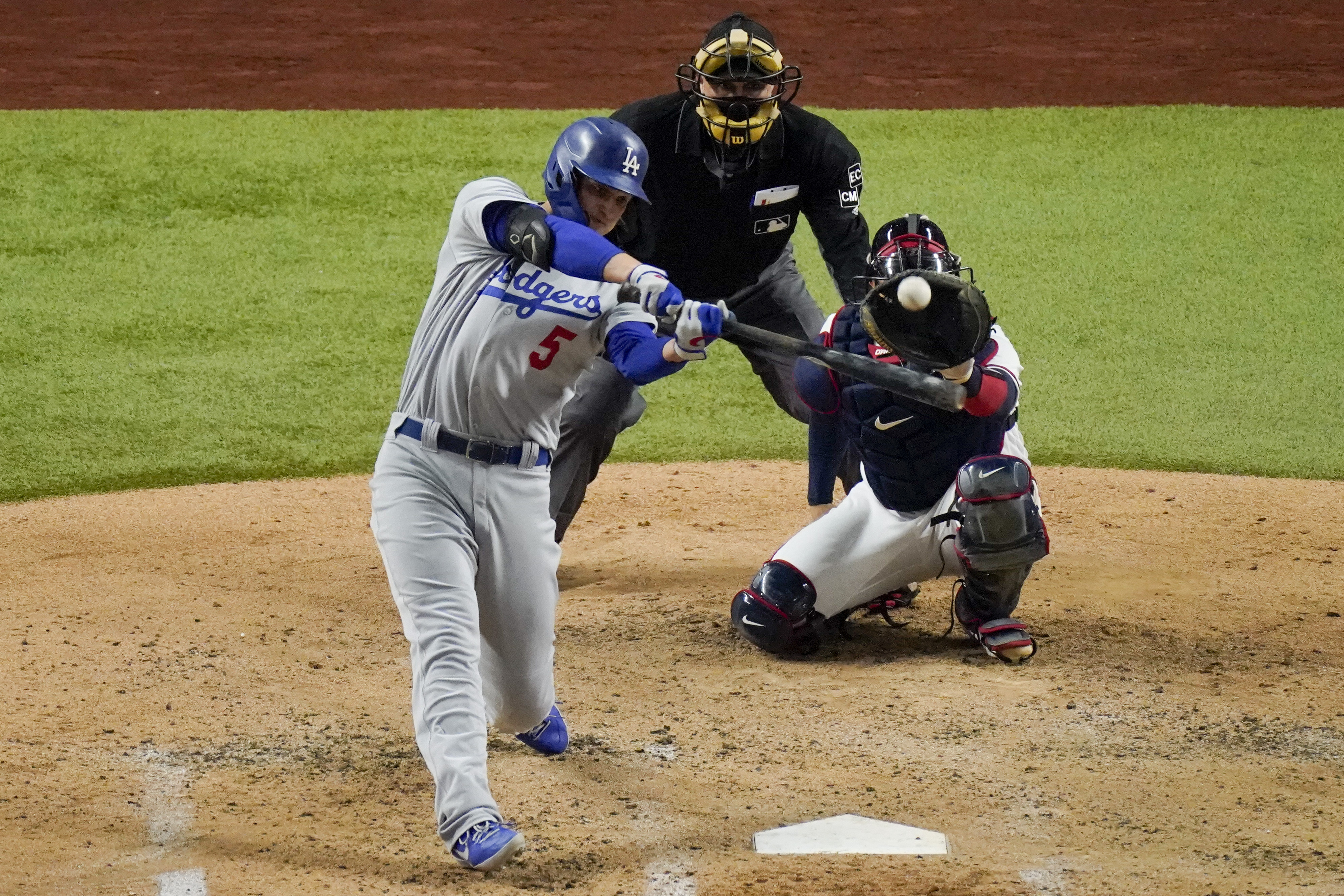 Los Angeles Dodgers' Corey Seager hits a home run against the Atlanta Braves during the fourth inning in Game 5 of a baseball National League Championship Series Friday, Oct. 16, 2020, in Arlington, Texas. (AP Photo/Sue Ogrocki)