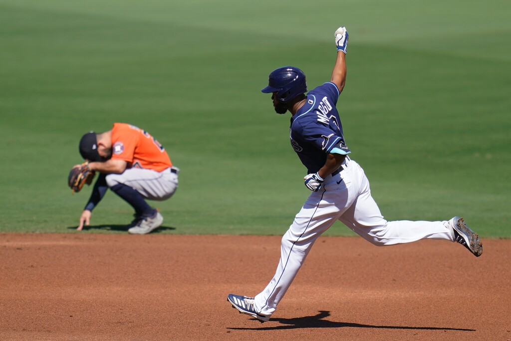 Tampa Bay Rays Manuel Margot rounds the bases past Houston Astros' Jose Altuve after hitting a three run home run against Houston Astros starting pitcher Lance McCullers Jr. during the first inning in Game 2 of a baseball American League Championship Series, Monday, Oct. 12, 2020, in San Diego. (AP Photo/Gregory Bull)