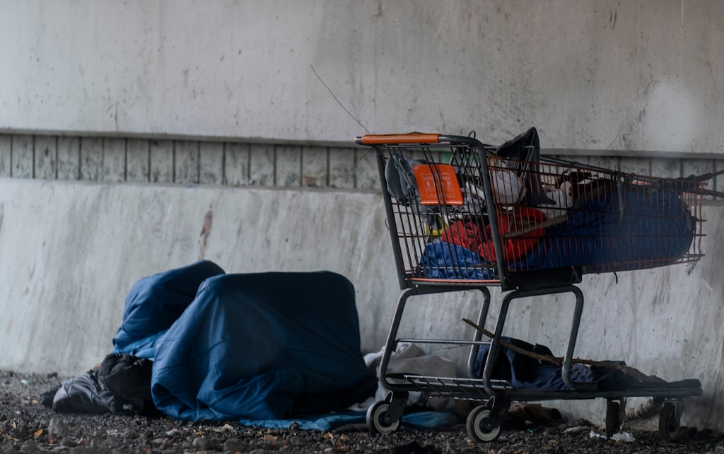(Rick Egan | The Salt Lake Tribune) A man recently seeking shelter under the 500 South overpass in Salt Lake City. With homelessness running high, the city is boosting its available shelter beds and stepped up police patrols along the Jordan River.