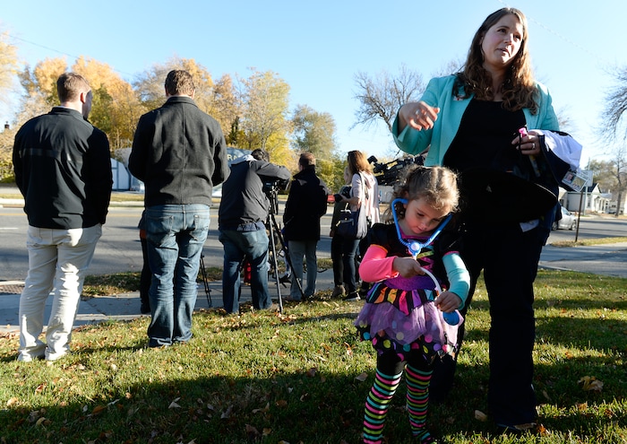 (Francisco Kjolseth  |  The Salt Lake Tribune)  Amy Davis is joined by her daughter Tovah, 3, as she talks about Halloween night two years ago when her daughter, and three other family members were struck by a truck turning left across traffic in Sugarhouse. Tovah and two cousins were being pulled by their grandfather in a wagon when they were struck along with an uncle. Severely injured, the family returned to the same intersection to relay their story in an effort to keep other trick-or-treaters safe this Halloween. 