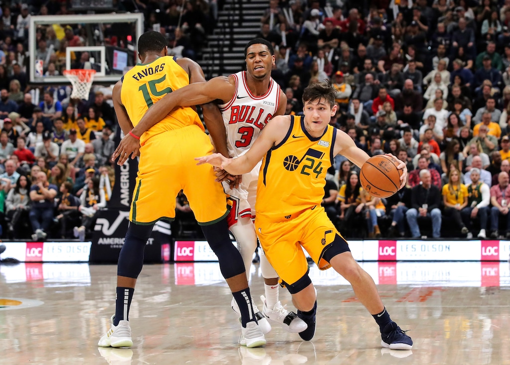 Utah Jazz guard Grayson Allen (24) uses forward Derrick Favors (15) to get away from Chicago Bulls guard Shaquille Harrison (3) during the second quarter of an NBA basketball game Saturday, Jan. 12, 2019, in Salt Lake City. (AP Photo/Chris Nicoll)