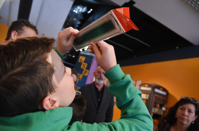 (Francisco Kjolseth | The Salt Lake Tribune) Bryson Tyler, 14, looks at the film strip from a Jackie Chan movie embedded within a ruler after the actor and environmental champion stopped in to a student workshop as part of a preview of Jackie ChanÕs Inaugural Environmental Exhibition ÔJackie Chan: Green HeroÕ at The Leonardo: Museum of Creativity and Innovation on Thursday, Jan. 24, 2019.
