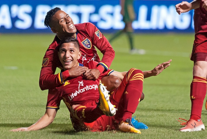 (Michael Mangum  |  Special to the Tribune)  Real Salt Lake forward Joao Plata (10) tackles Real Salt Lake forward Jefferson Savarino (7) to the ground in celebration of Savarino's second half goal during their MLS match against the Portland Timbers at Rio Tinto Stadium in Sandy, UT on Saturday, September 16, 2017.