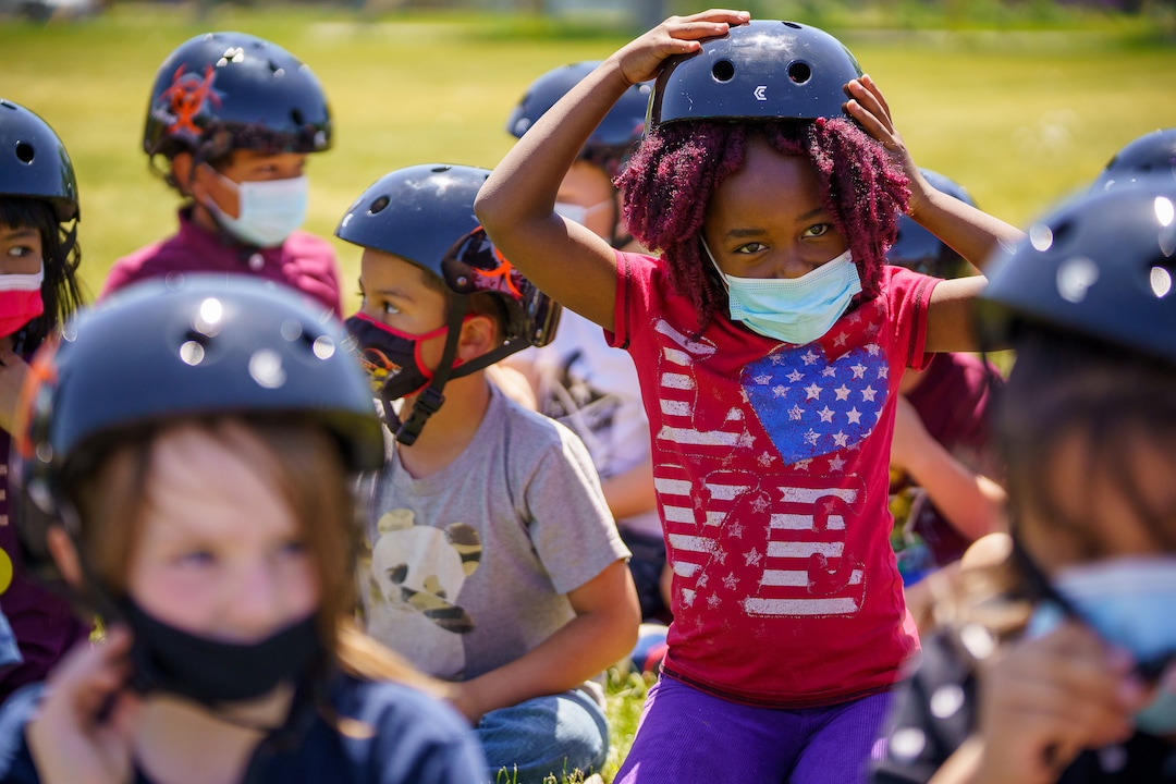 (Trent Nelson  |  The Salt Lake Tribune) 1st grade students at Mary W. Jackson Elementary try on their new helmets as volunteers with Can’d Aid, a non-profit, hand out new bikes in Salt Lake City on Thursday, May 13, 2021.