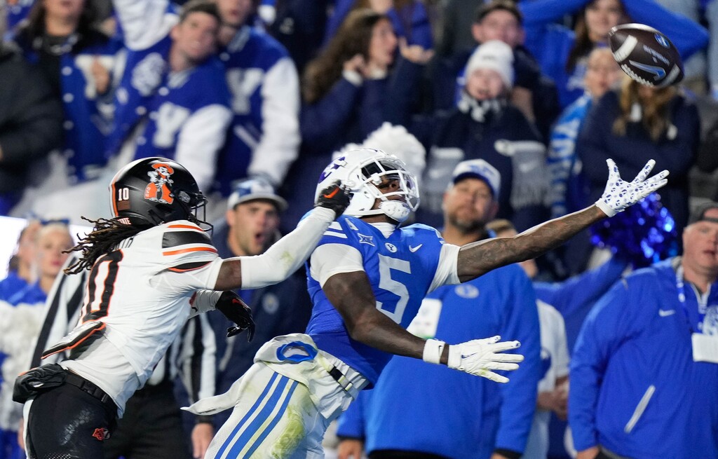 (Francisco Kjolseth  | The Salt Lake Tribune) Brigham Young Cougars wide receiver Darius Lassiter (5) stretches out for a long pass attempt against the Oklahoma State Cowboys in Provo on Friday, Oct. 18, 2024.