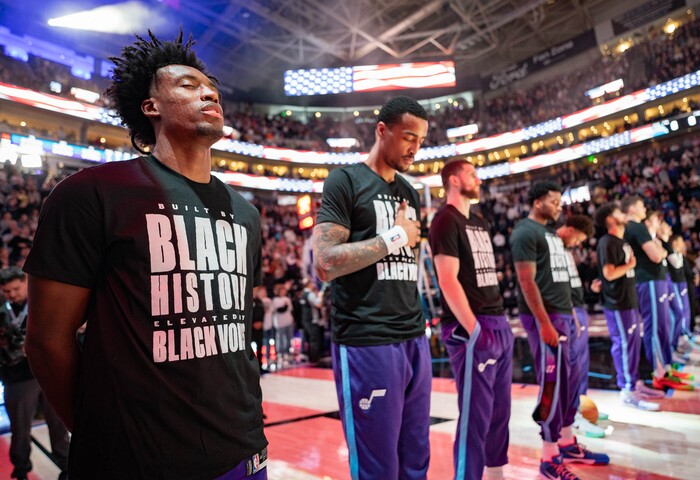 (Francisco Kjolseth  | The Salt Lake Tribune) Utah Jazz guard Collin Sexton (2) and Utah Jazz forward John Collins (20) join the rest of the team during the national anthem as they get ready to take on the Orlando Magic during NBA basketball at the Delta Center in Salt Lake City on Saturday, February. 1, 2025.