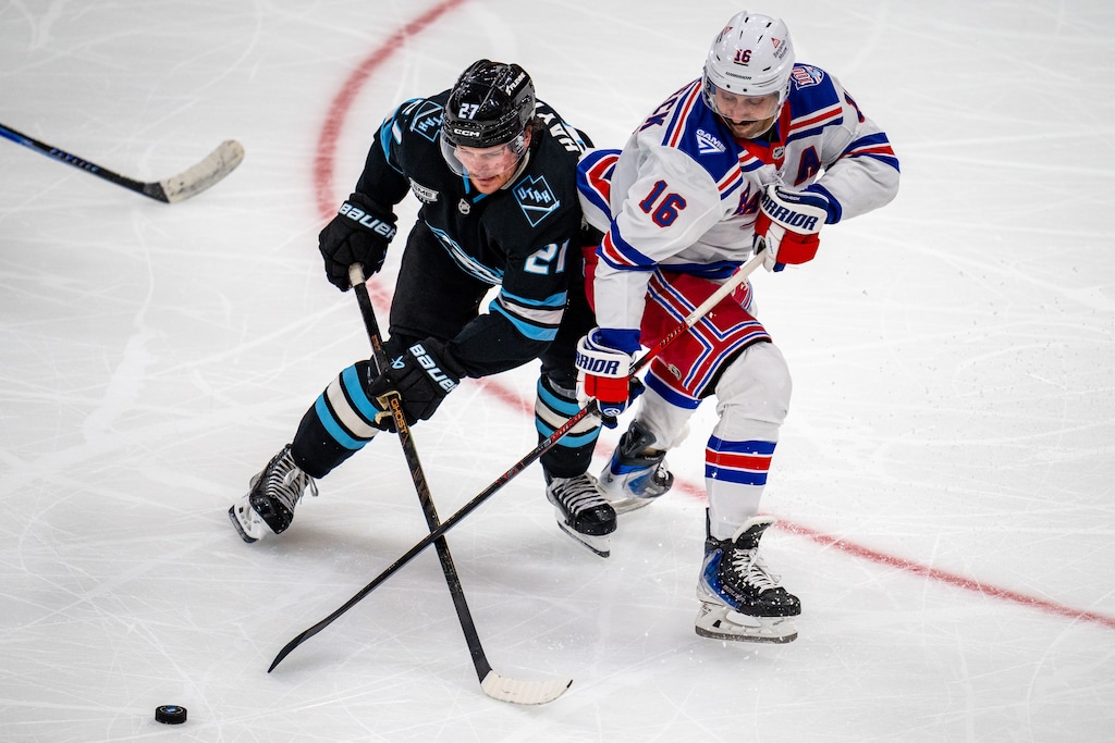 (Trent Nelson  |  The Salt Lake Tribune) Utah Mammoth center Barrett Hayton (27) and New York Rangers center Vincent Trocheck (16) battle for the puck last season. Trocheck has been traded to Utah, according to reports.