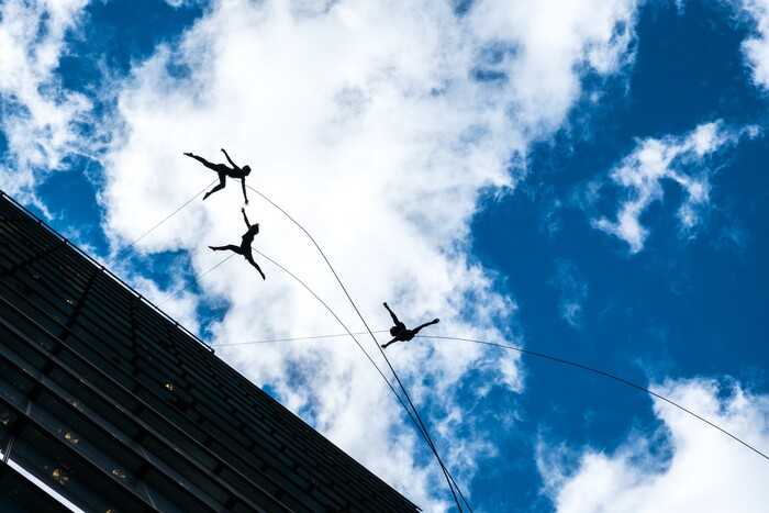 (Photo courtesy of Basil Tsimoyianis) Oakland, Calif.-based “vertical dance” company BANDALOOP performs in Sydney, Australia. They will be appearing at the Utah Arts Festival June 21-24, and will perform twice daily (5:30 and 7 p.m.) on the six-story library glass wall above the reflecting pool.