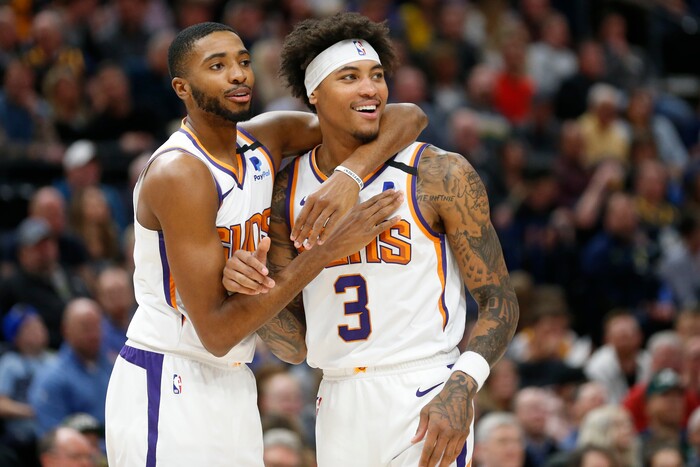 Phoenix Suns forward Mikal Bridges, left, and forward Kelly Oubre Jr. (3) react to a foul called on Oubre in the first half during an NBA basketball game against the Utah Jazz, Monday, Feb. 24, 2020, in Salt Lake City. (AP Photo/Rick Bowmer)