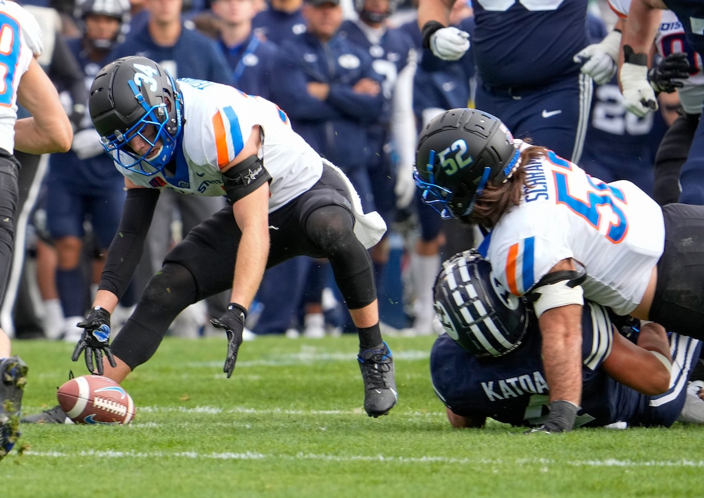 (Leah Hogsten | The Salt Lake Tribune) Boise State Broncos safety Alexander Teubner (34) picks up a fumble from Brigham Young Cougars running back Lopini Katoa (4) right, after he was tackled by Boise State Broncos linebacker DJ Schramm (52) as No. 10 Brigham Young University hosts Boise State at LaVell Edwards Stadium, Oct. 9, 2021. 