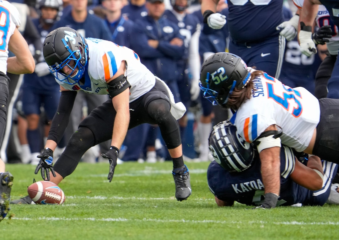 (Leah Hogsten | The Salt Lake Tribune) Boise State Broncos safety Alexander Teubner (34) picks up a fumble from Brigham Young Cougars running back Lopini Katoa (4) right, after he was tackled by Boise State Broncos linebacker DJ Schramm (52) as No. 10 Brigham Young University hosts Boise State at LaVell Edwards Stadium, Oct. 9, 2021.