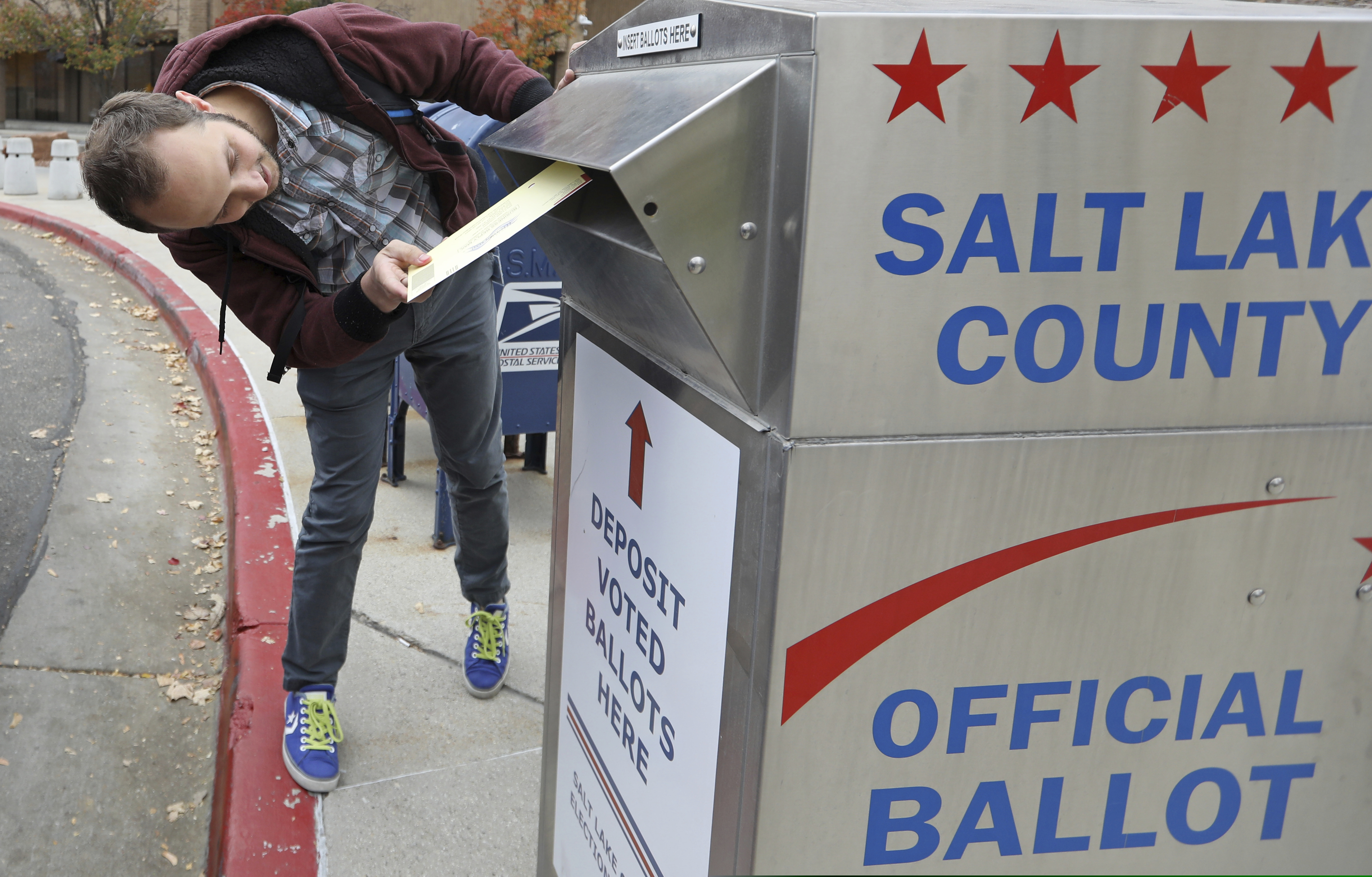 In this Wednesday, Oct. 31, 2018, photo, a voter drops off his ballot in Salt Lake City. (AP Photo/Rick Bowmer)