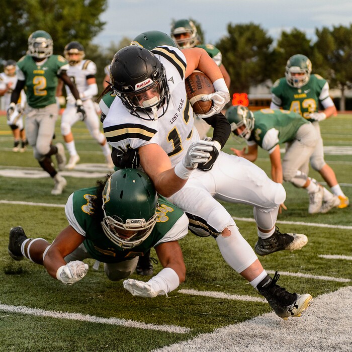 (Trent Nelson | The Salt Lake Tribune) Lone Peak's Masen Wake is knocked out of bounds as Kearns hosts Lone Peak, high school football, Thursday September 14, 2017.