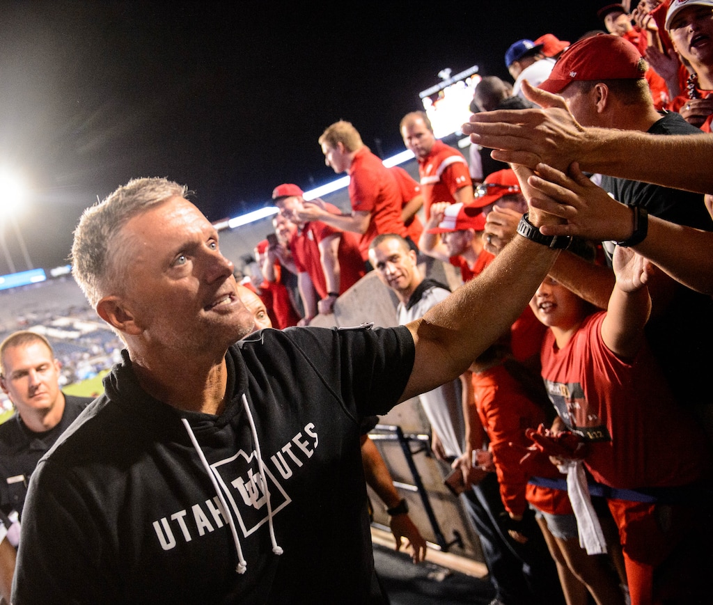 (Trent Nelson  |  The Salt Lake Tribune)  Utah coach Kyle Whittingham high-fives fans after the win, as Brigham Young University (BYU) hosts the University of Utah, NCAA football in Provo on Friday Aug. 30, 2019.