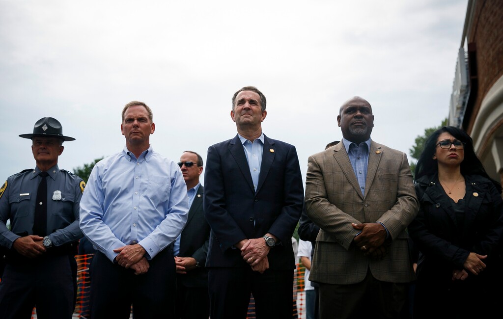 Virginia Gov. Ralph Northam, center, attends a vigil held to honor the lives lost in a mass shooting Saturday, June 1, 2019 in Virginia Beach, Va. DeWayne Craddock, a longtime city employee, opened fire at the municipal building Friday before police shot and killed him, authorities said. (Kristen Zeis/The Virginian-Pilot via AP)