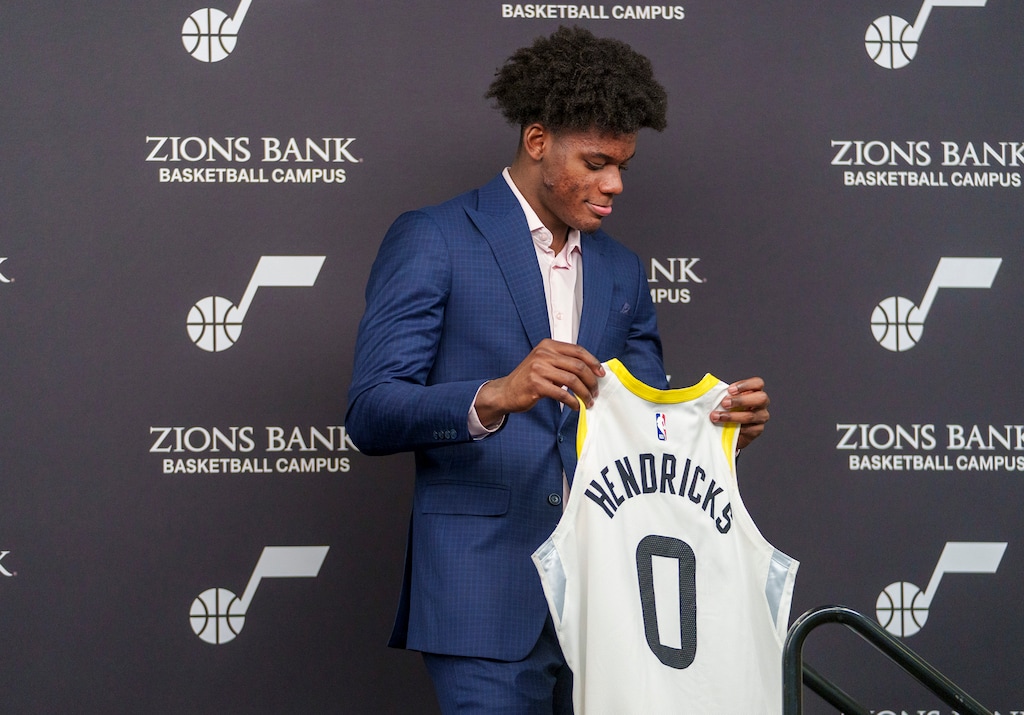 (Leah Hogsten | The Salt Lake Tribune) Taylor Hendricks, the No. 9 Utah Jazz's NBA draft pick, holds his Jazz jersey for the first time at the Utah Jazz Basketball Center, June 26, 2023. 