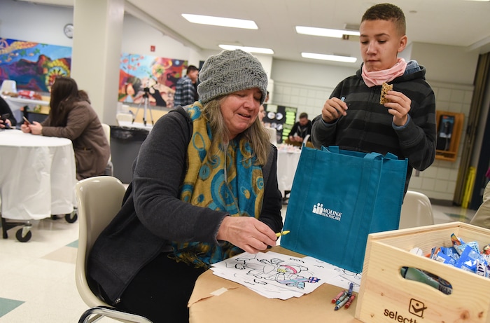 (Francisco Kjolseth  |  The Salt Lake Tribune)  Carol Davis colors with crayons and talks with her son Dante, 11, while attending the Winter De-Stressor Festival at the Horizonte Instruction and Training Center in Salt Lake on Saturday, Dec. 15, 2018. The event helped families identify and locate services or programs for youths between Christmas and New Years.