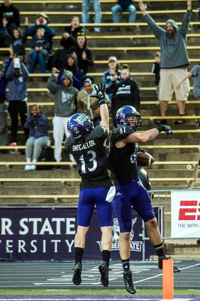 (Chris Detrick  |  The Salt Lake Tribune)  Weber State Wildcats tight end Andrew Vollert (87) and Weber State Wildcats wide receiver Drew Batchelor (13) celebrate after Vollert scored a touchdown past Western Illinois Leathernecks Tyrin Holloway (16) during the game at Stewart Stadium Saturday, November 25, 2017.  