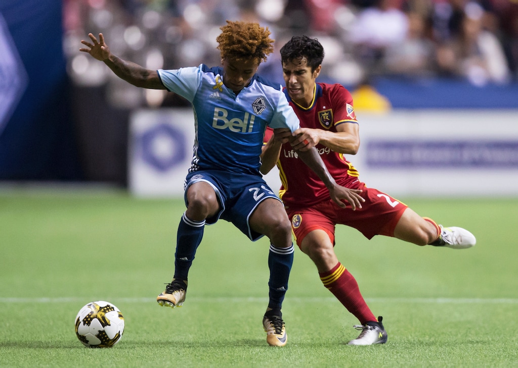 Vancouver's Yordy Reyna, left, and Real Salt Lake's Tony Beltran vie for the ball during the first half of their match Saturday in Vancouver, British Columbia. (Darryl Dyck/The Canadian Press via AP)