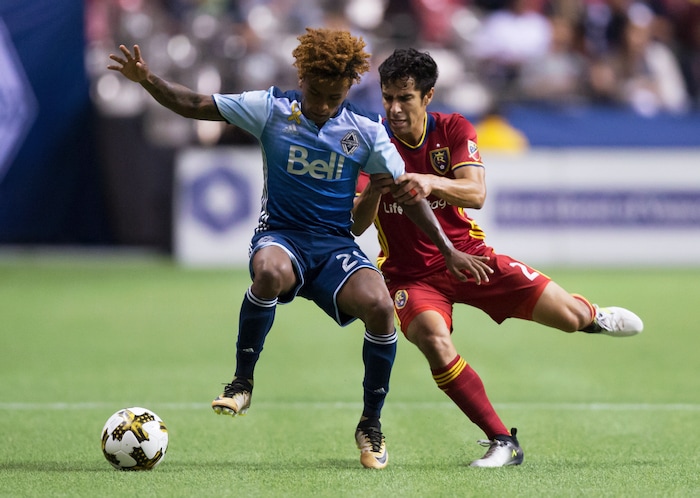 Vancouver Whitecaps' Yordy Reyna, left, and Real Salt Lake's Tony Beltran vie for the ball during the first half of an MLS soccer match Saturday, Sept. 9, 2017, in Vancouver, British Columbia. (Darryl Dyck/The Canadian Press via AP)