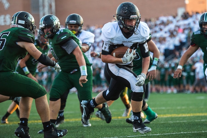 (Chris Detrick  |  The Salt Lake Tribune)    Highland's Matthew Parkin (24) runs for a touchdown past Hillcrest's Will Hutchings (26) during the game at Hillcrest High School Friday, September 1, 2017. 