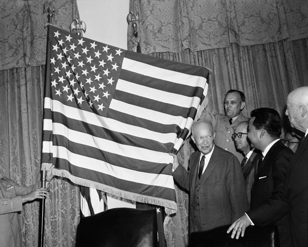 (Byron Rollins | AP file photo)
In this Aug. 21, 1959, photo, President Dwight Eisenhower helps unfurl the new 50-star flag in Washington after signing a proclamation making Hawaii the 50th state of the union. At right is Daniel K. Inouye, Democratic congressman-elect from Hawaii.