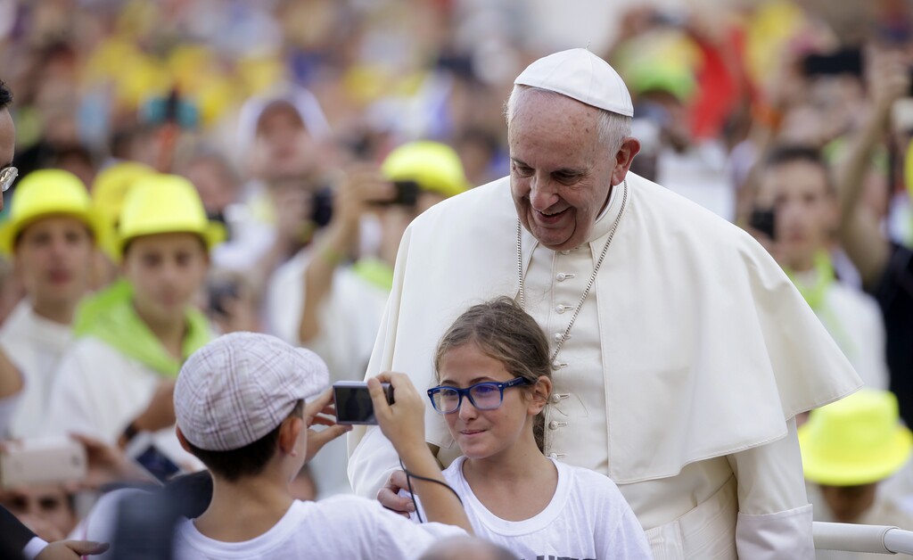 (AP Photo/Gregorio Borgia, File) In this Tuesday, Aug. 4, 2015, file photo, Pope Francis poses for a photo as he arrives in St. Peter's Square at the Vatican for an audience with with Altar boys and girls. Francis thrills Democrats with his teachings on climate change, social justice and immigration. At the same time, his message on life and the Catholic Church's traditional opposition to abortion comfort Republicans.