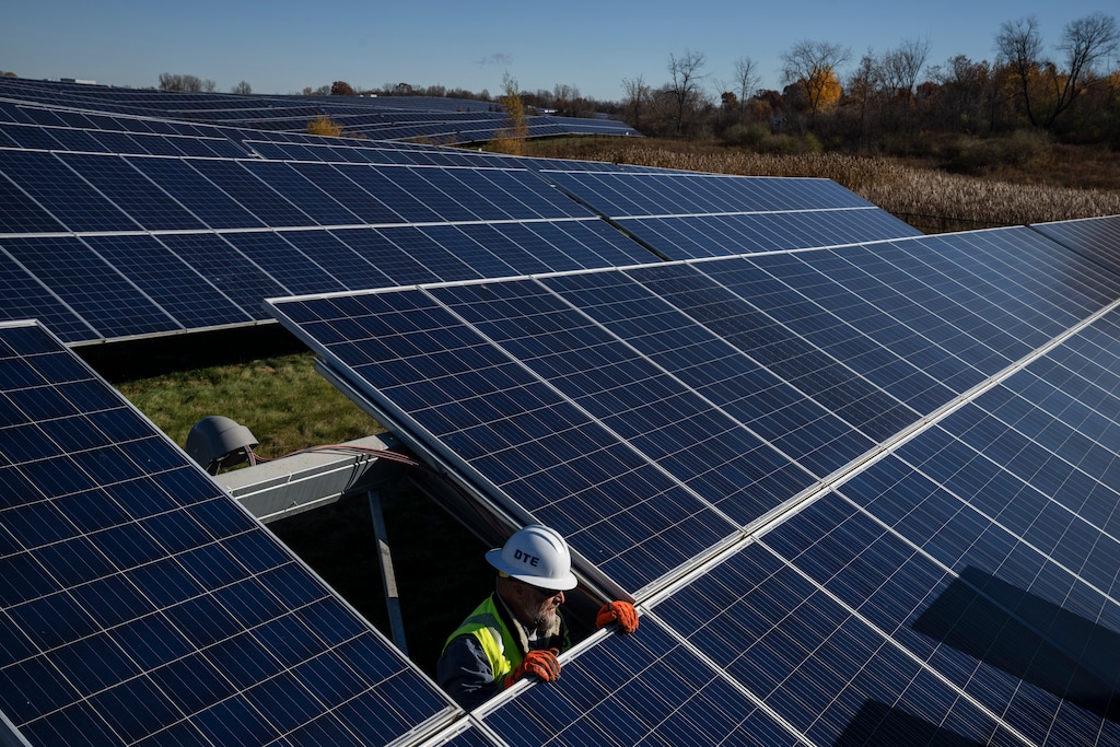 (Todd Heisler | The New York Times) A worker replaces arrays at a DTE solar park in Lapeer, Mich. on Oct. 27, 2022. The Energy Department said on Jan. 16, 2025 that it planned to offer $22.9 billion in loan guarantees to help eight electric utilities around the country modernize their power grids, add large amounts of renewable energy — and pass along any resulting savings to customers.