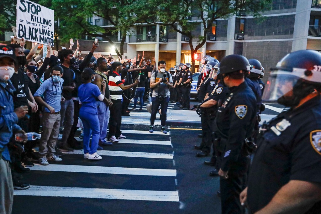 (Frank Franklin II | AP file photo) Protesters confront New York Police officers as part of a solidarity rally calling for justice over the death of George Floyd, Wednesday, June 3, 2020, in the Brooklyn borough of New York. Floyd died after being restrained by Minneapolis police officers on Memorial Day.