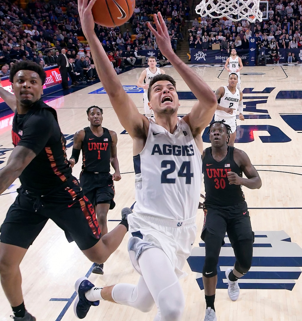 Utah State guard Diogo Brito (24) shoots as UNLV forward Tervell Beck, left, defends during an NCAA college basketball game Saturday, Feb. 2, 2019, in Logan, Utah. (Eli Lucero/The Herald Journal via AP)