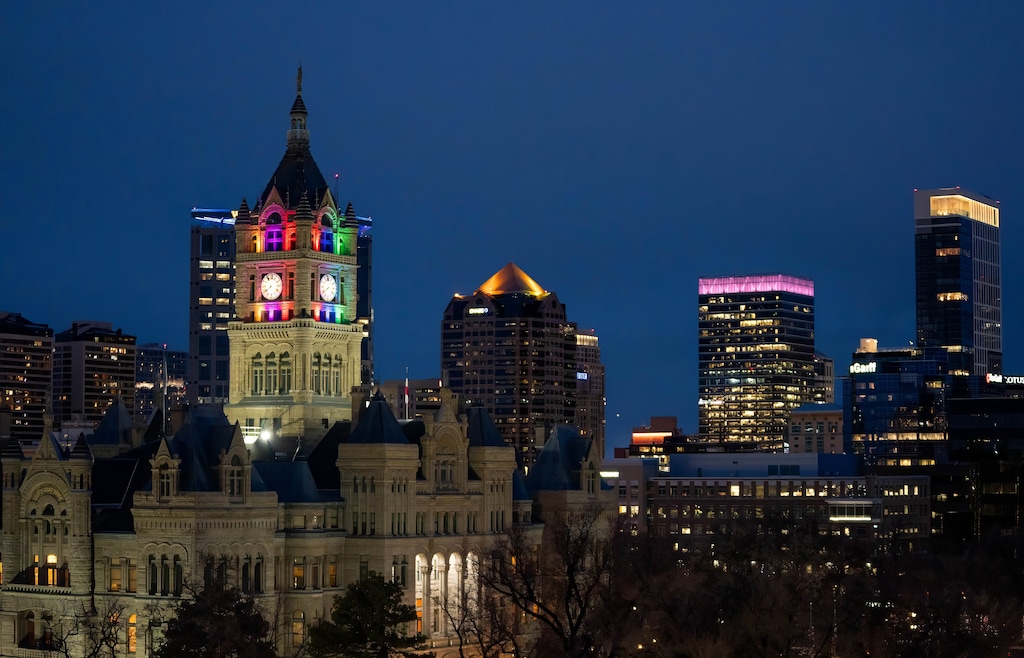 (Francisco Kjolseth | The Salt Lake Tribune) The clock tower at City Hall is lit up with pride colors on Saturday, March 15, 2025. Salt Lake City Mayor Erin Mendenhall, one of the leaders involved in Utah’s bid to keep Sundance, flew the pride flag outside and lit the tower to show opposition to HB77, which would ban pride flags in Utah schools and public buildings.