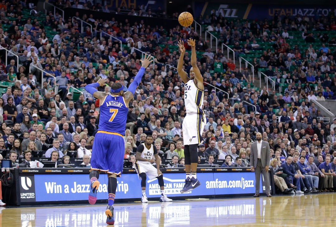 Utah Jazz guard Rodney Hood (5) shoots as New York Knicks forward Carmelo Anthony (7) defends during the second quarter of an NBA basketball game Wednesday, Dec. 9, 2015, in Salt Lake City. (AP Photo/Rick Bowmer)  